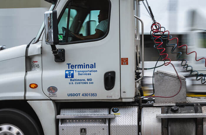 closeup of truck driver in the cab of a truck