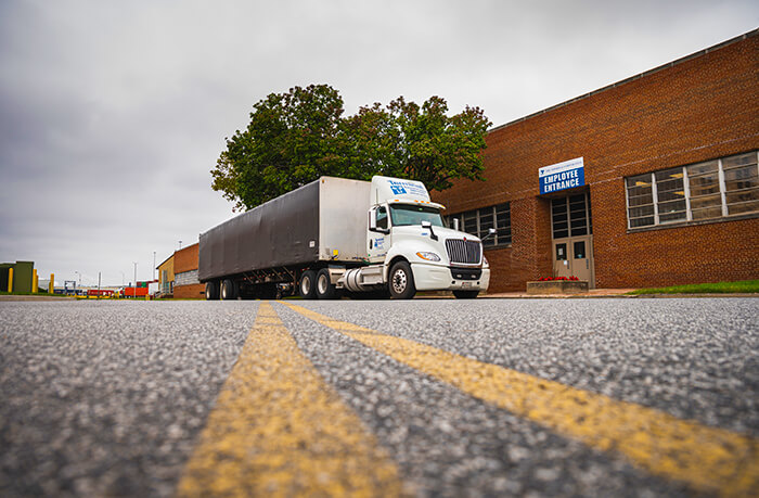 conestoga flatbed parked in front of terminal transportation services office building