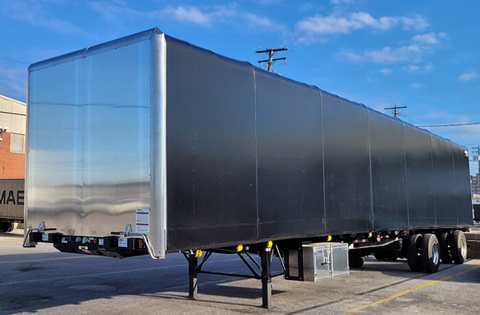 dconestoga trailer parked on side of the road